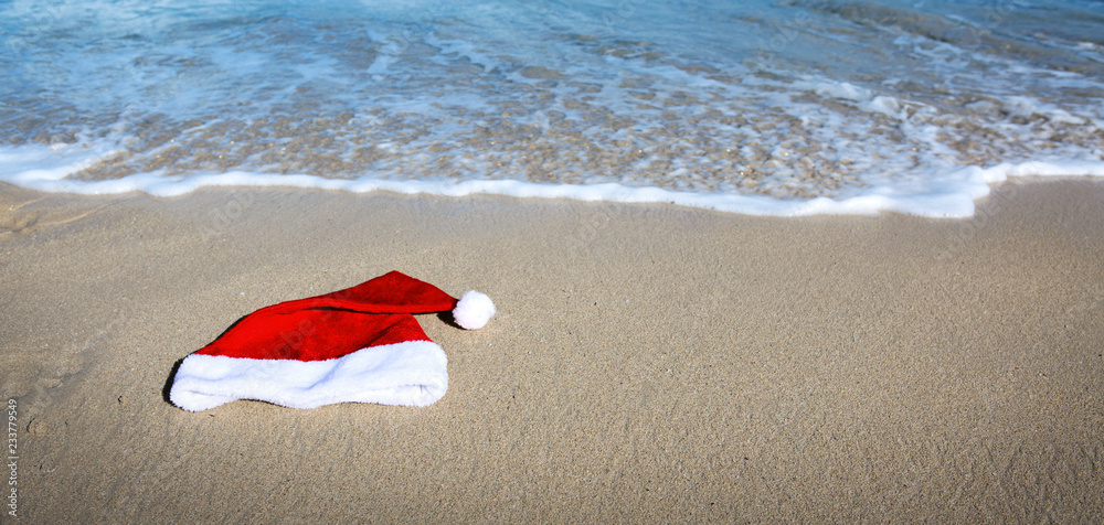 Santa Claus hat on caribbean beach. Christmas background Santa Claus hat on caribbean beach. Christmas background