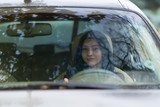 Woman driving a car viewed through the windscreen