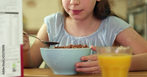 Close Up Of Girl Eating Unhealthy Bowl Of Sugary Breakfast Cereal In Kitchen