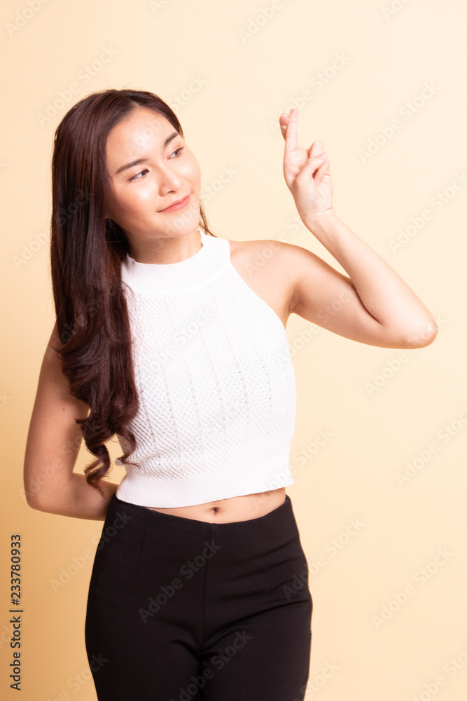 Beautiful young Asian woman cross finger. Beautiful young Asian woman cross finger.