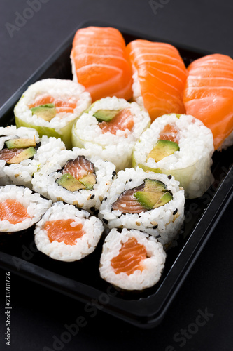 sushi pack with nigiri and maki on black background. Close up