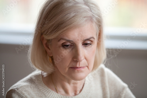 Close up of sad senior woman sorrow or grieve for beloved husband feeling lonely, upset aged female thinking about past memories, missing old days, concerned old lady remembering or recalling