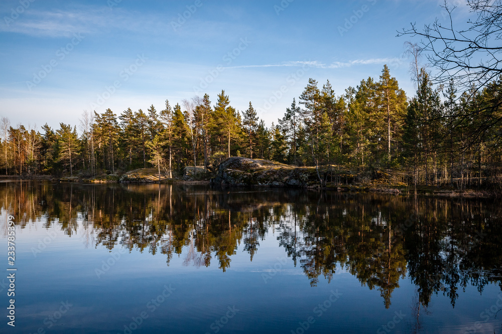 Fototapeta premium colorful sunset on the lake with water reflections and dramatic storm clouds above