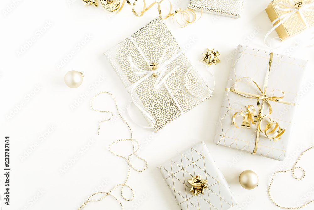 Fototapeta premium Christmas, New Year holiday composition with golden gift boxes, decorations on white background. Flat lay, top view of gifts packaging.
