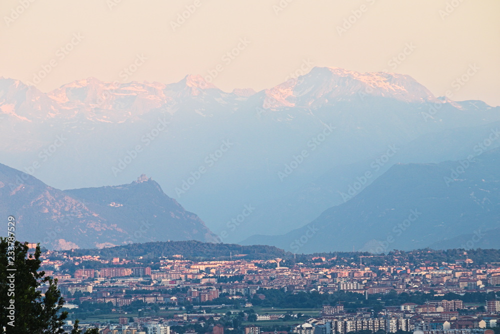 Panorama on the city of Turin at dawn, skyline with the Alps in the background