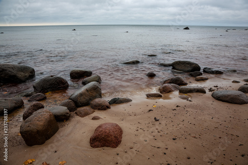 rocky coastline in Latvia with flow water in the sea and large rocks