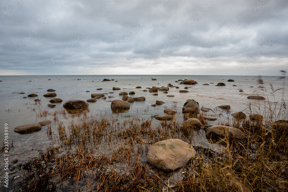 rocky coastline in Latvia with flow water in the sea and large rocks rocky coastline in Latvia with flow water in the sea and large rocks
