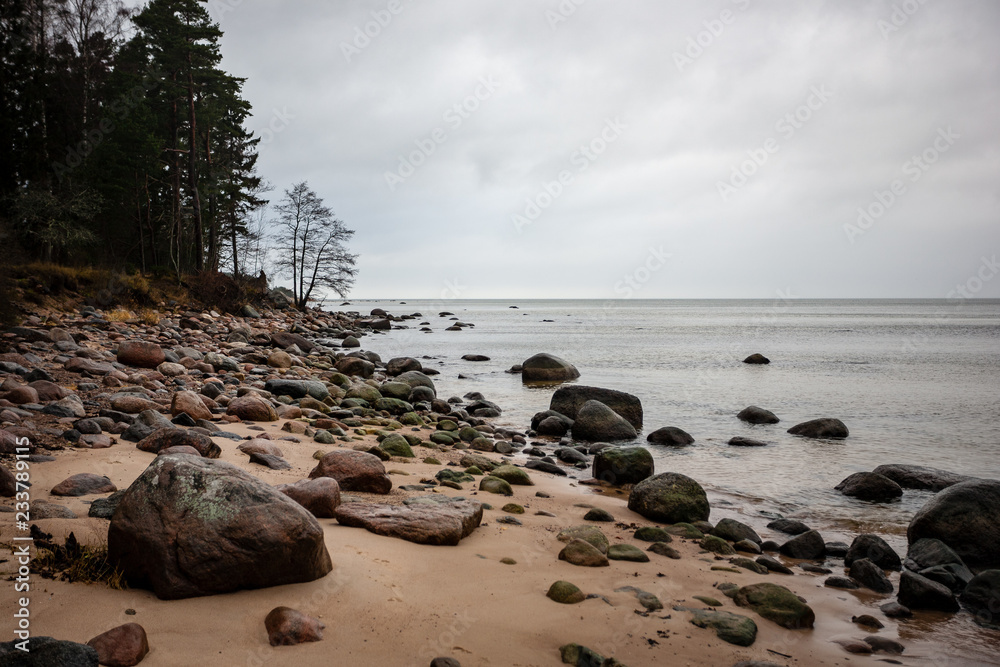 rocky coastline in Latvia with flow water in the sea and large rocks