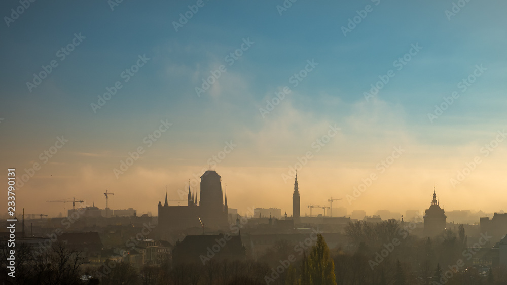 Foggy and cloudy cityscape of Gdansk with St. Mary's Basilica.
