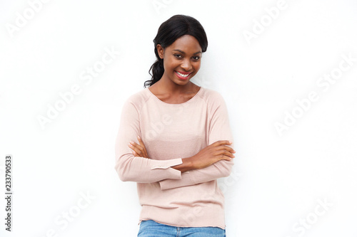 beautiful young black woman posing with arms crossed against isolated white background © mimagephotos