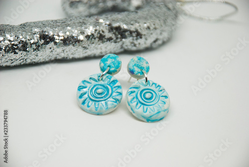 Small light blue winter stud earrings of polymer clay with christmas decor. Handmade jewelry isolated.