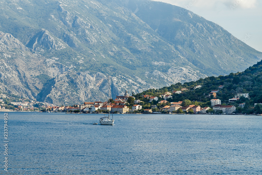 The city on the beach at the foot of the high mountains in the Bay of Kotor