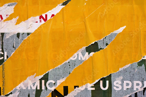 Old grunge ripped torn vintage collage street posters creased crumpled paper surface placard texture background backdrop