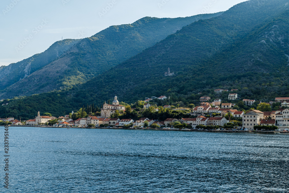 The city on the beach at the foot of the high mountains in Montenegro