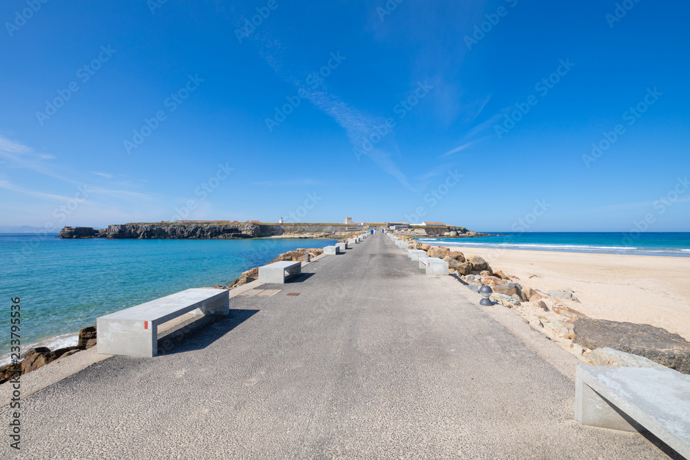 asphalt road and breakwaters to Isla Palomas, Pigeon Island, from Tarifa town in Cadiz (Andalusia, Spain, Europe). In fact, is an isthmus