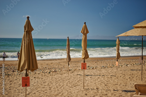 sun umbrellas closed on the beach