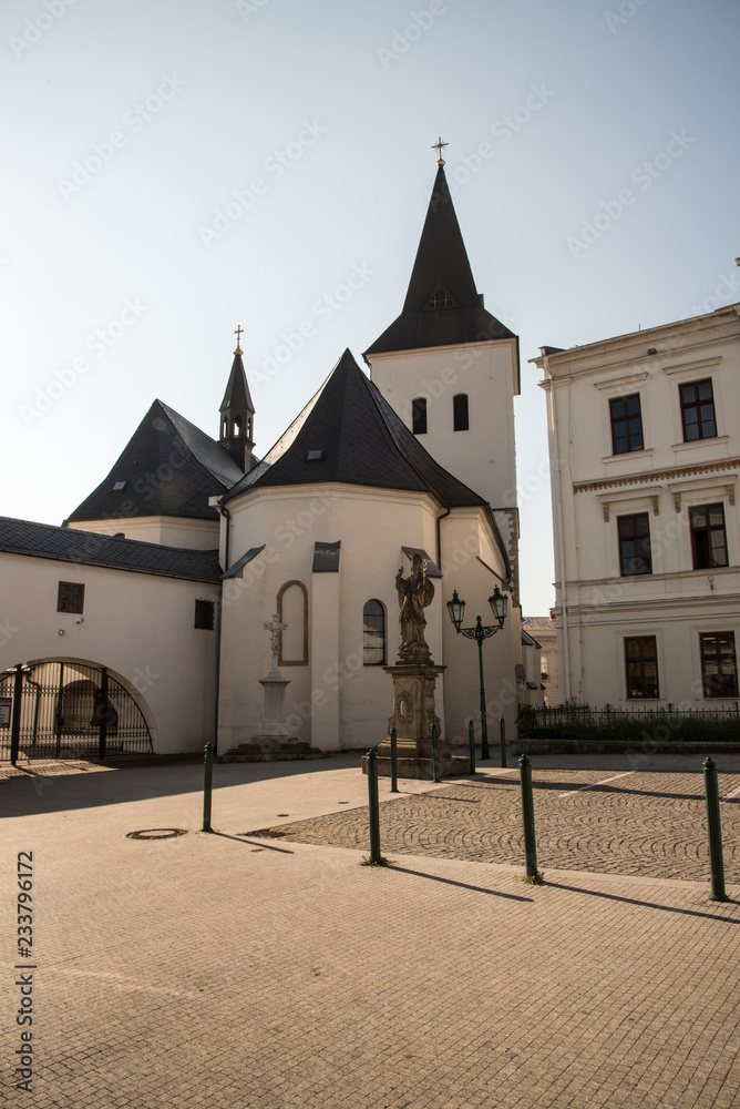 Obraz premium Kostel Povyseni sv. Krize church with statue of sv. Florian behind in Karvina city in Czech republic