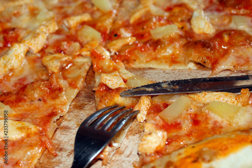 appetizing pizza cut by knife and fork
