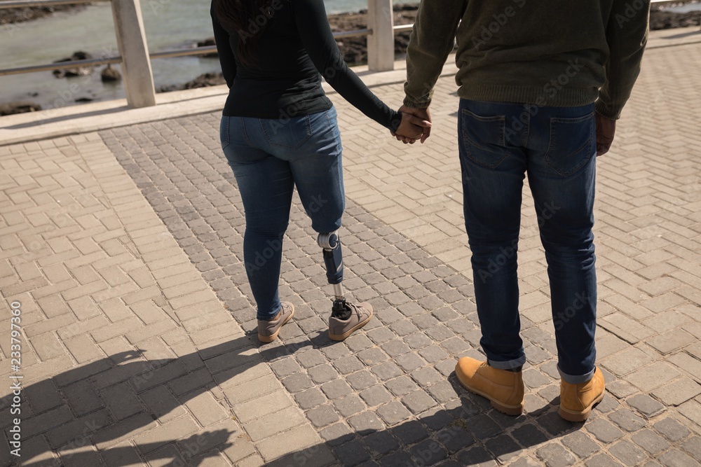 Couple holding hands on promenade Couple holding hands on promenade