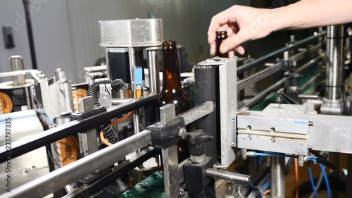 Wallpaper Mural Food industry. Automatic Beer Bottling Line. Applying the label. Machine for pasting labels for beer bottles. 4k Torontodigital.ca