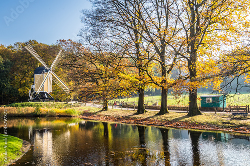 Historic Dutch scene with  wooden barn and water windmill in the open air museum in Arnhem in the Netherlands