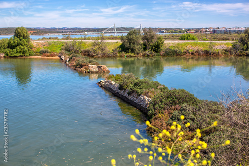 A small lake in the city of Portimao overlooking the new bridge and mountains. photo