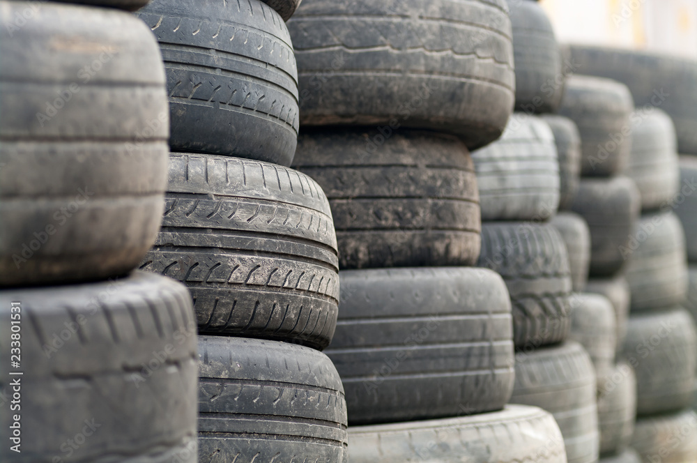 Used wheel tires stacked ready for recycling. Used wheel tires stacked ready for recycling.