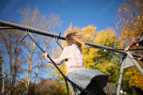 Photo of girl swinging in autumn park