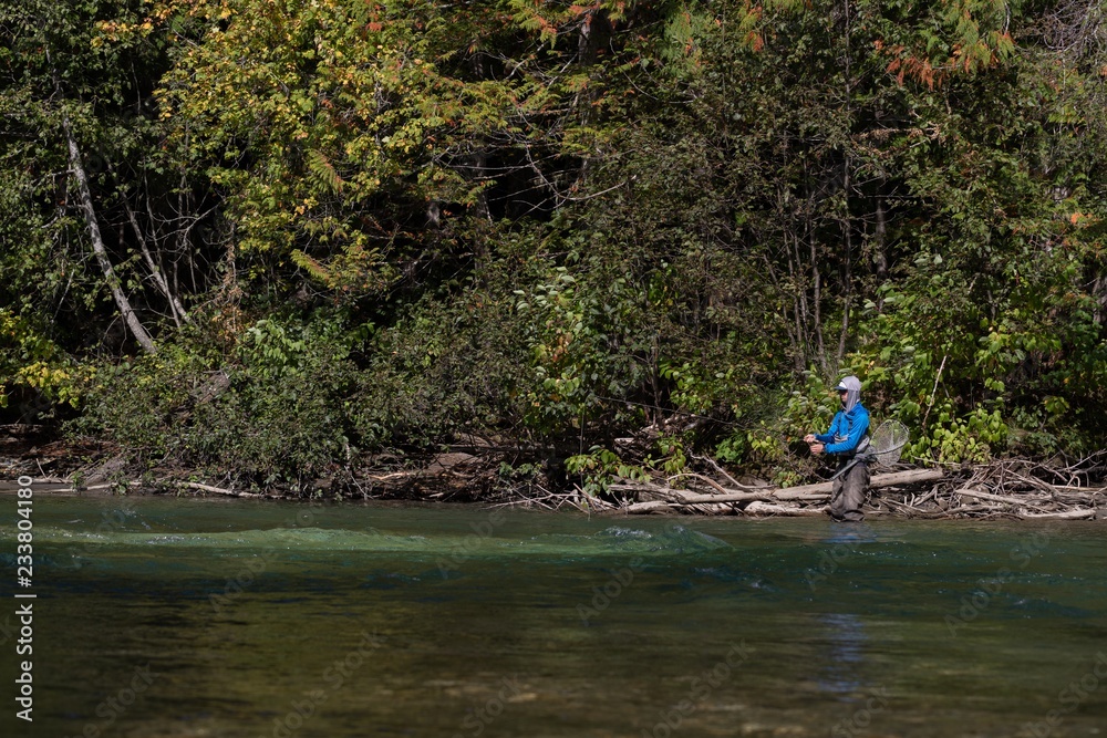 Fisherman fly fishing in river Fisherman fly fishing in river