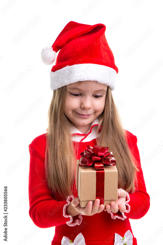 Happy christmas girl holding and lookning at the gift it in the hands, wearing a santa hat isolated over a white background Happy christmas girl holding and lookning at the gift it in the hands, wearing a santa hat isolated over a white background