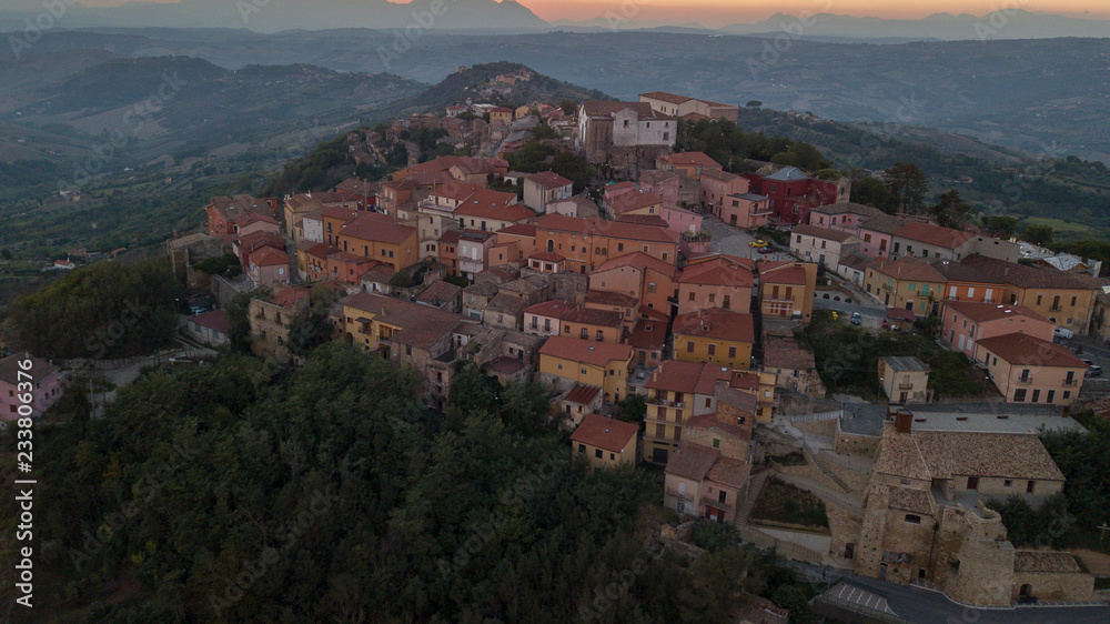 Aerial view at sunset of the small town of Montecalvo Irpino, in the province of Avellino, in Italy. This village with few houses and streets is built in the mountains of Irpinia.