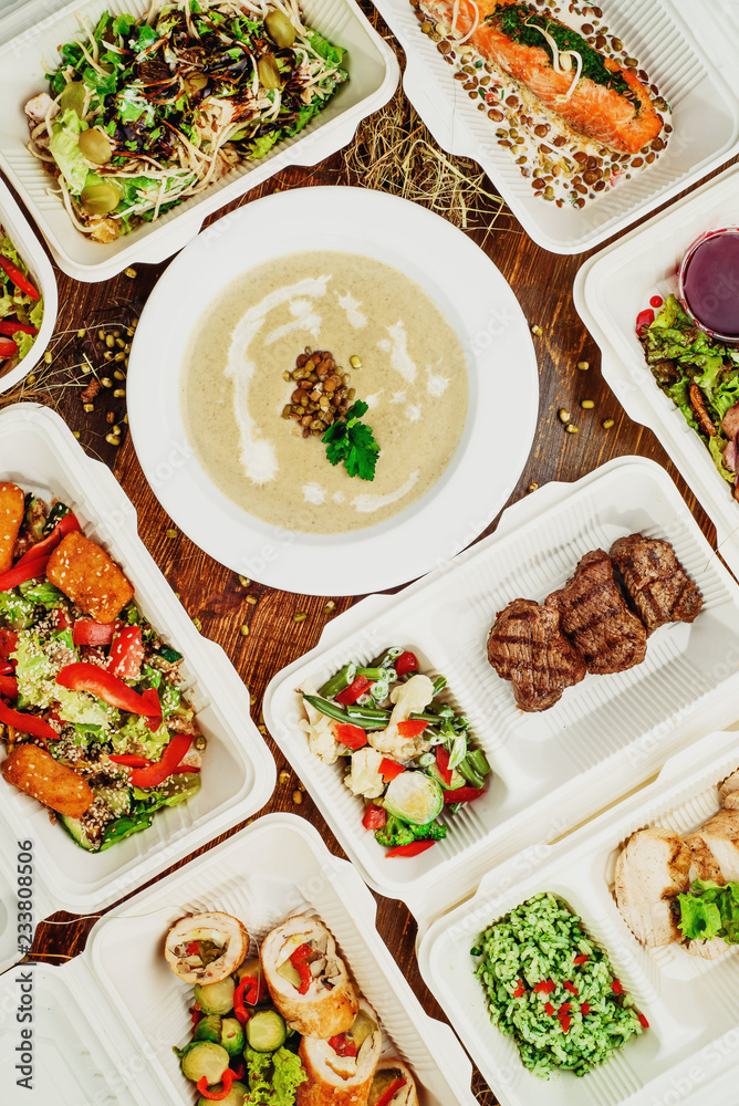 Healthy food delivery. Take away for diet. Fitness nutrition, vegetables, meat and fruits in white eco boxes. Top view, flat lay at natural wood with copy space