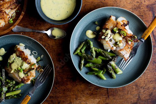 Overhead view of hake with asparagus and aioli served on plate photo
