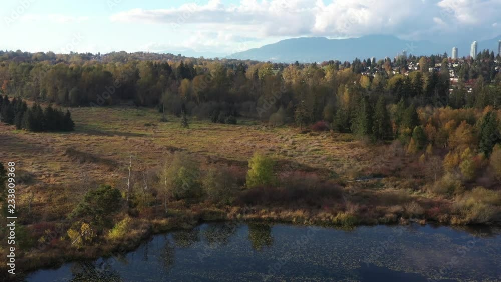 Aerial View at Mountain Lake on sunny and cloud fall afternoon in British Columbia, Canada. Mountains background. Aerial View at Mountain Lake on sunny and cloud fall afternoon in British Columbia, Canada. Mountains background.