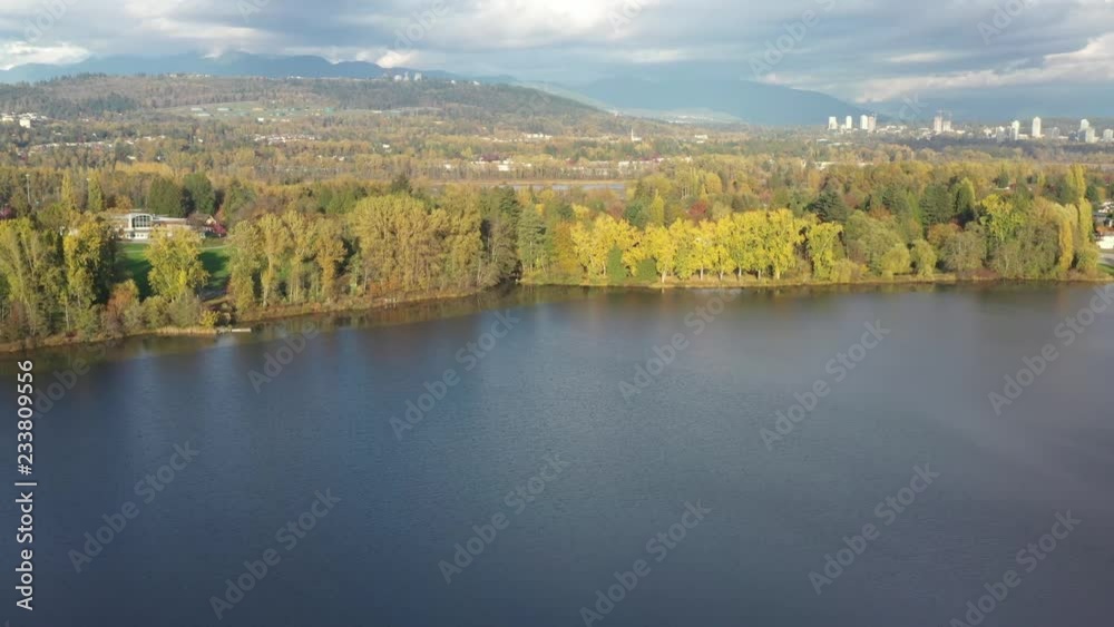 Aerial View at Mountain Lake on sunny and cloud fall afternoon in British Columbia, Canada. Mountains background. Aerial View at Mountain Lake on sunny and cloud fall afternoon in British Columbia, Canada. Mountains background.