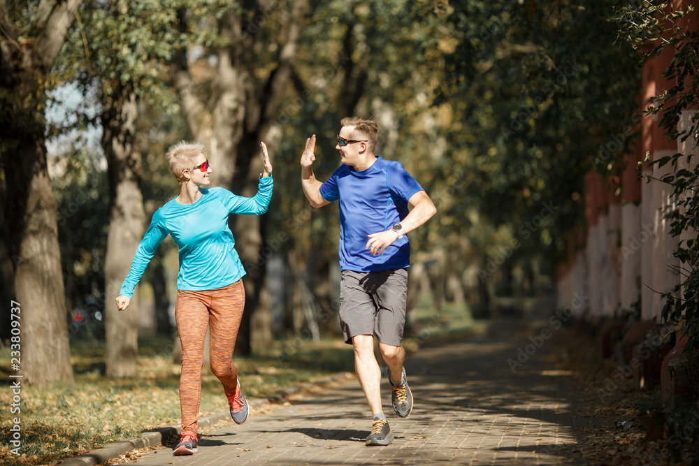 Fototapeta premium Photo of sporting man and woman doing handshake on morning jog