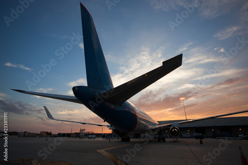 Airplane in airport at sunset