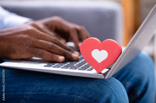 Heartshape On Keypad While Man Using Laptop