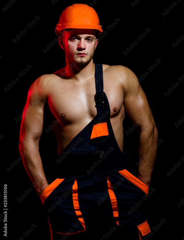 Making your dreams come to life. Man worker with muscular sexy body.  Construction worker or builder. Handsome worker or workman. Muscular man  wear hard hat and uniform. Confident and strong Stock Photo