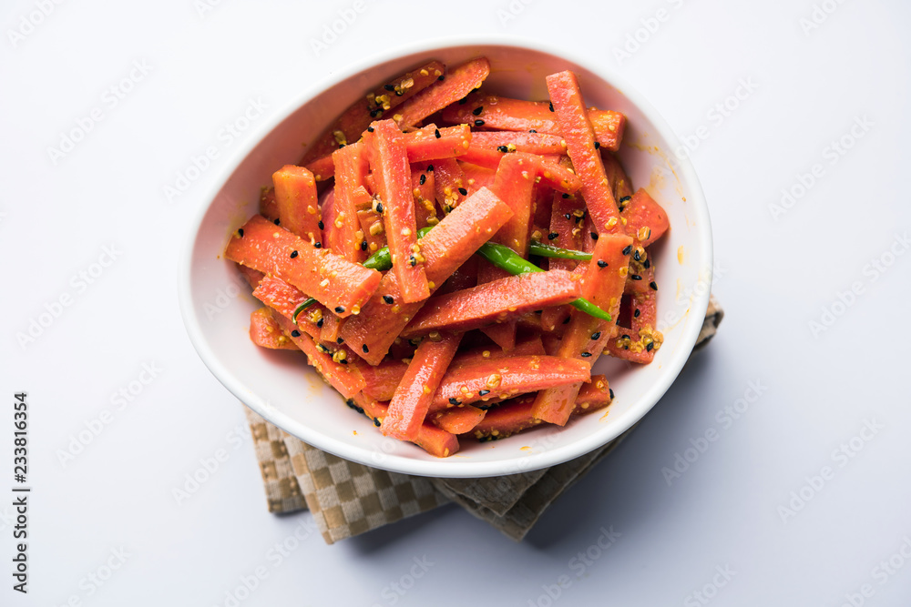 Carrot Pickle / Gajar ka Achar or Loncha in hindi. Served in a bowl over moody background. Selective focus Carrot Pickle / Gajar ka Achar or Loncha in hindi. Served in a bowl over moody background. Selective focus