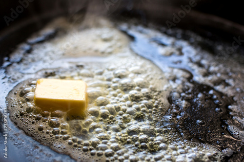 Close up of butter melting in frying pan photo