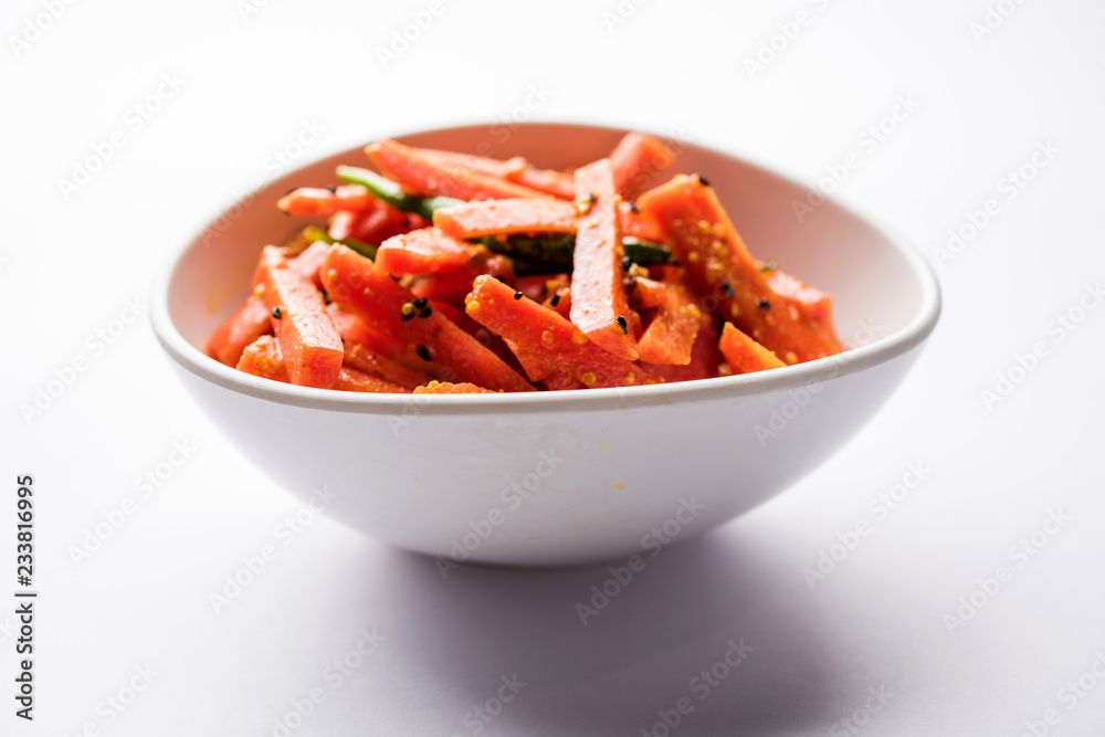 Carrot Pickle / Gajar ka Achar or Loncha in hindi. Served in a bowl over moody background. Selective focus Carrot Pickle / Gajar ka Achar or Loncha in hindi. Served in a bowl over moody background. Selective focus