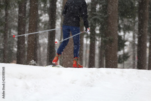 Particular of Cross-country skiing classic technique practiced by woman photo