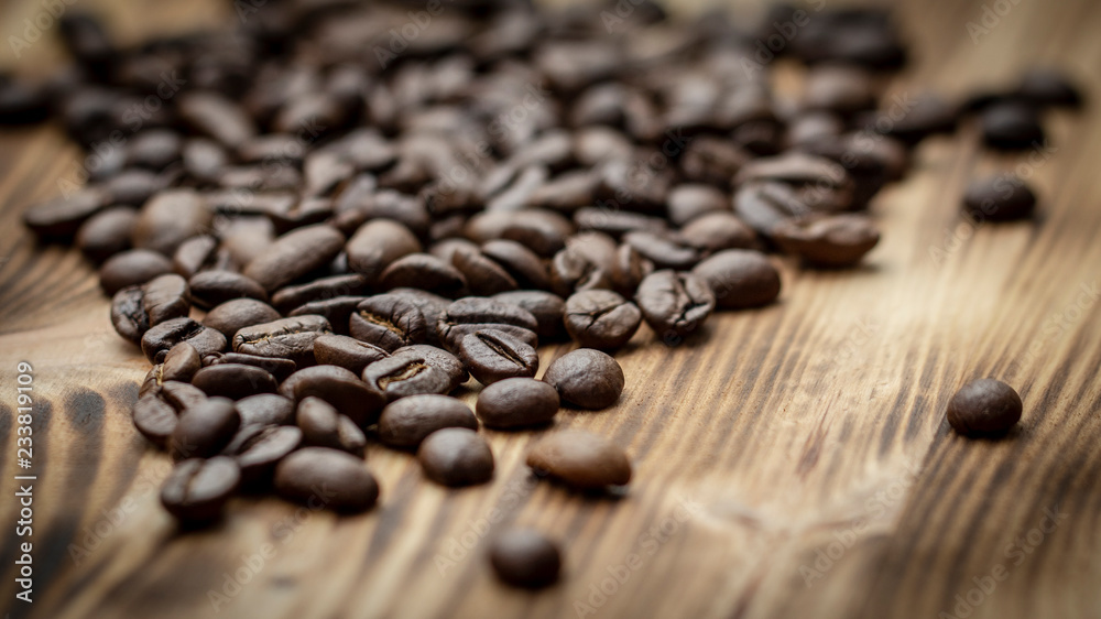 Coffee seeds on grunge wooden background close up