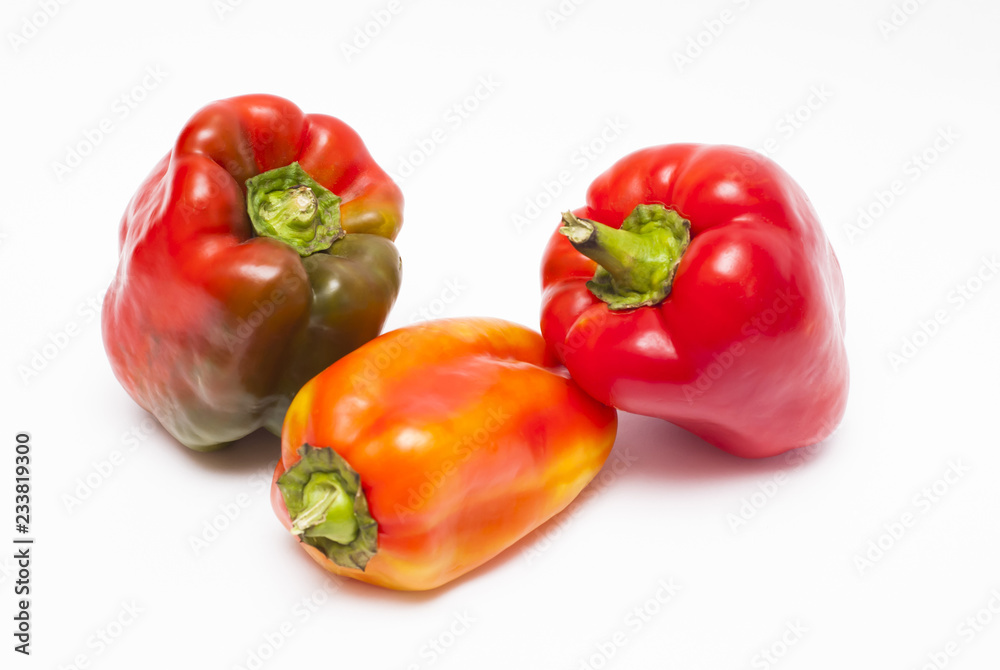 Ripe peppers of different colors close up on a white background Ripe peppers of different colors close up on a white background