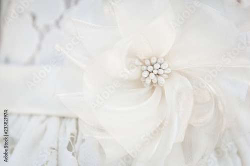 A close up look at the detail on a flower girls dress for a wedding. 