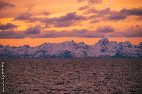 boat view to stunning purple sunset during Norway winter time