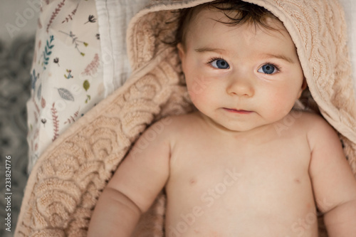 baby in towel after taking a bath