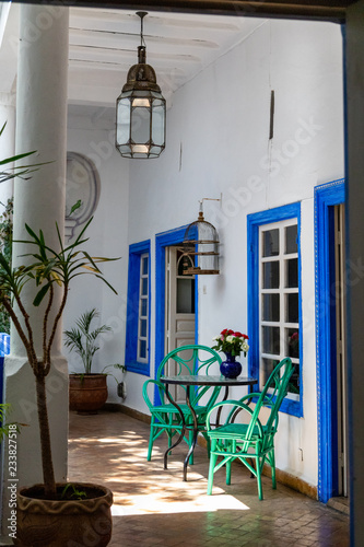 Patio with green chairs and blue framed windows