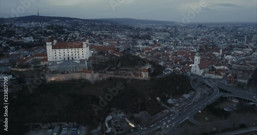 Wide Aerial shot of Bratislava castle and old town with Kamzik in background at twilight photo